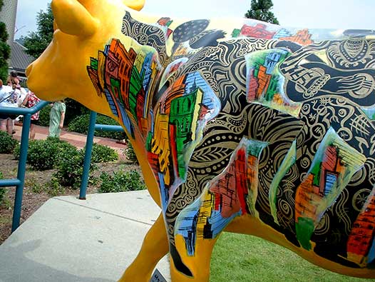 Cow Parade three-dimensional sculpture painting by Corey Barksdale at Piedmont Park, Atlanta