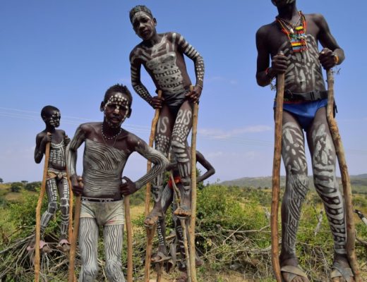 African tribal group wearing traditional ceremonial face and body paint