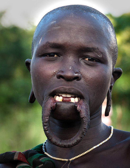 Mursi tribe woman with traditional lip stretching body modification